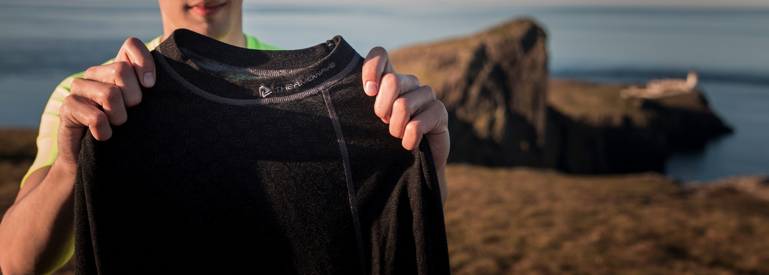 A man holds a thermoshirt