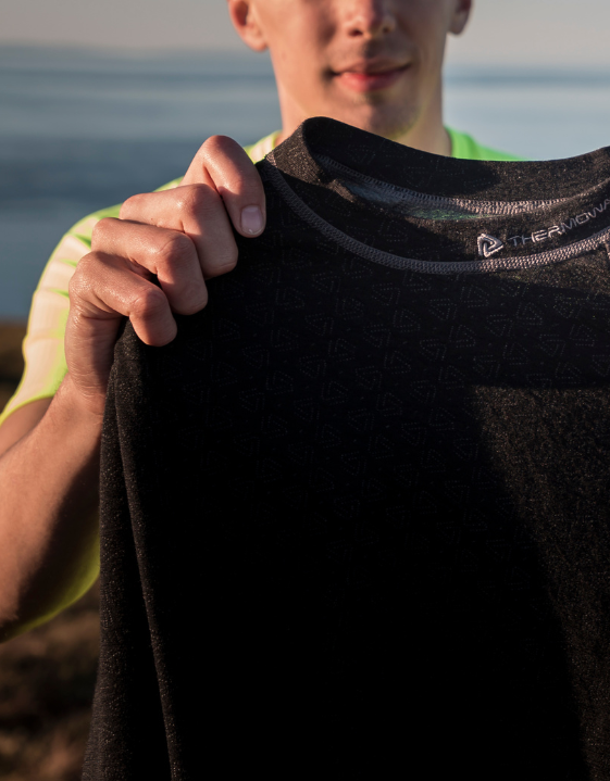 A man holds a thermoshirt