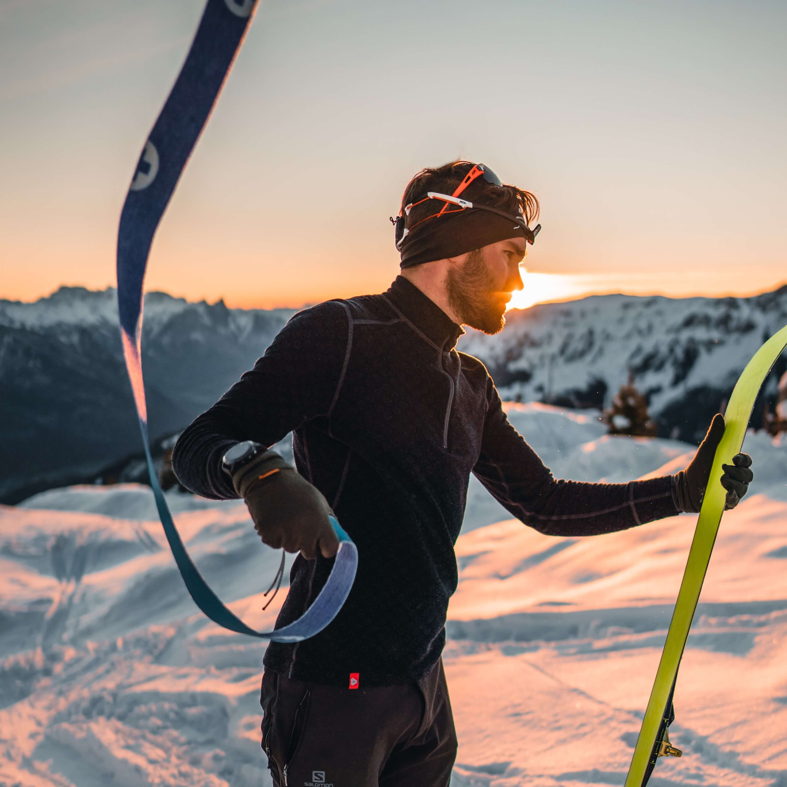 a-skier-on-top-of-the-mountain-during-sunset