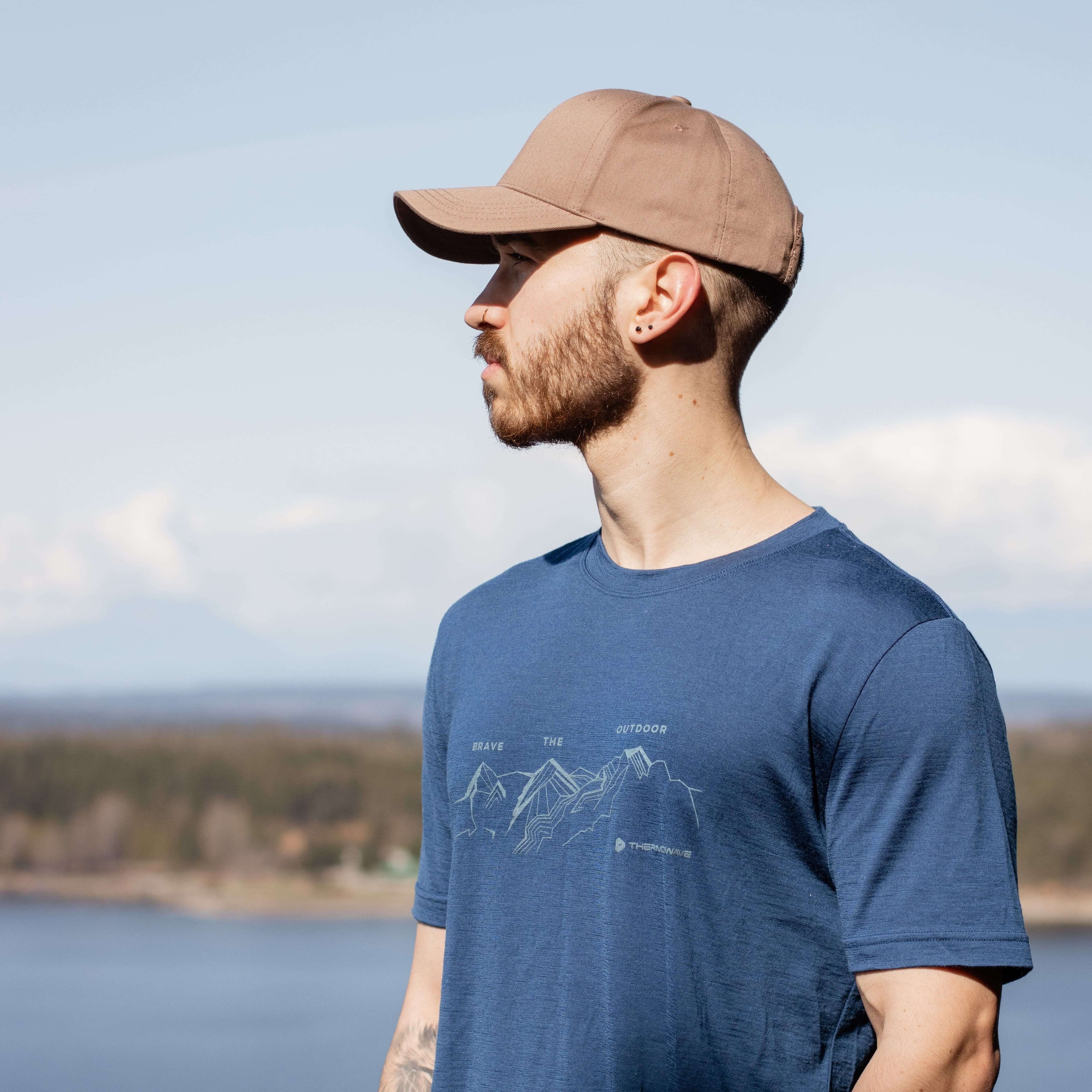 a-man-with-blue-t-shirt-with-mountains-logo